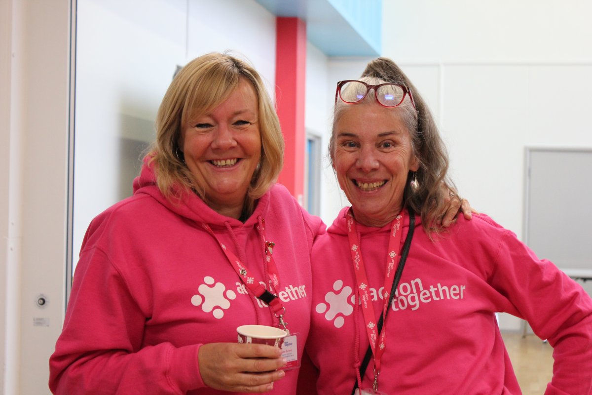 two people smiling in action together jumpers