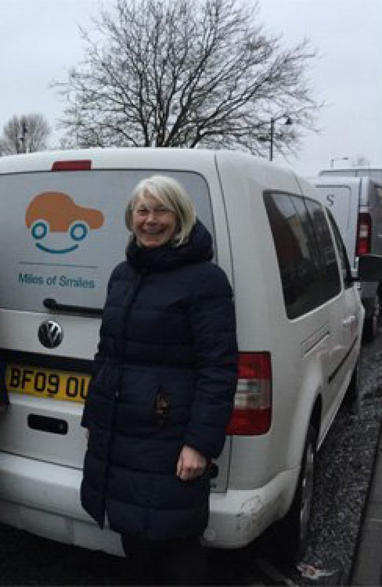 Miles of smiles van with person in front