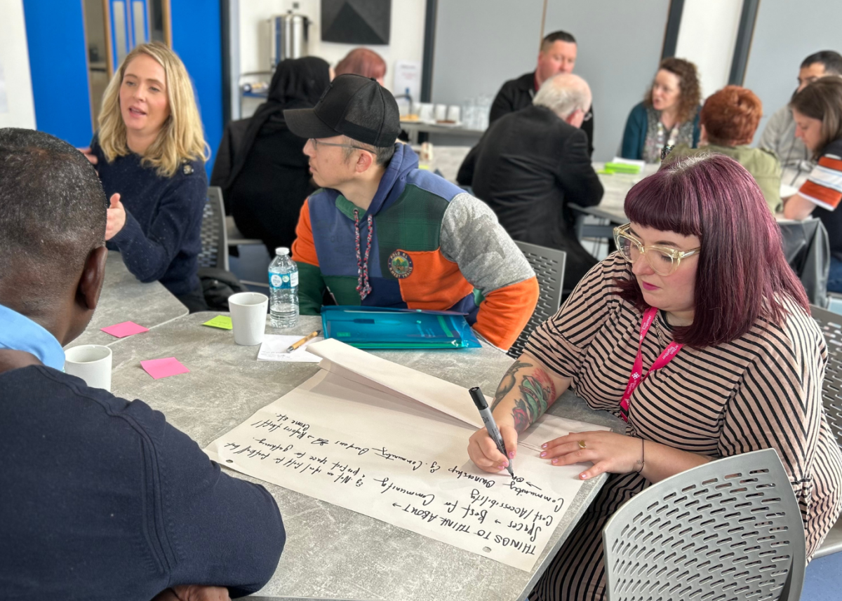 group of people around table making collaborative notes