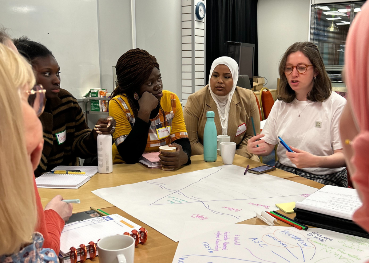 group of women in discussion and making group notes on flipchart paper