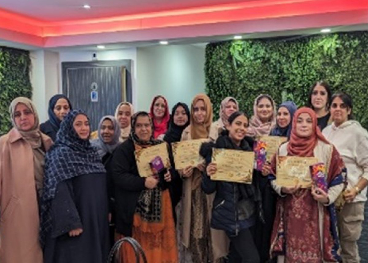 group of women smiling holding certificates