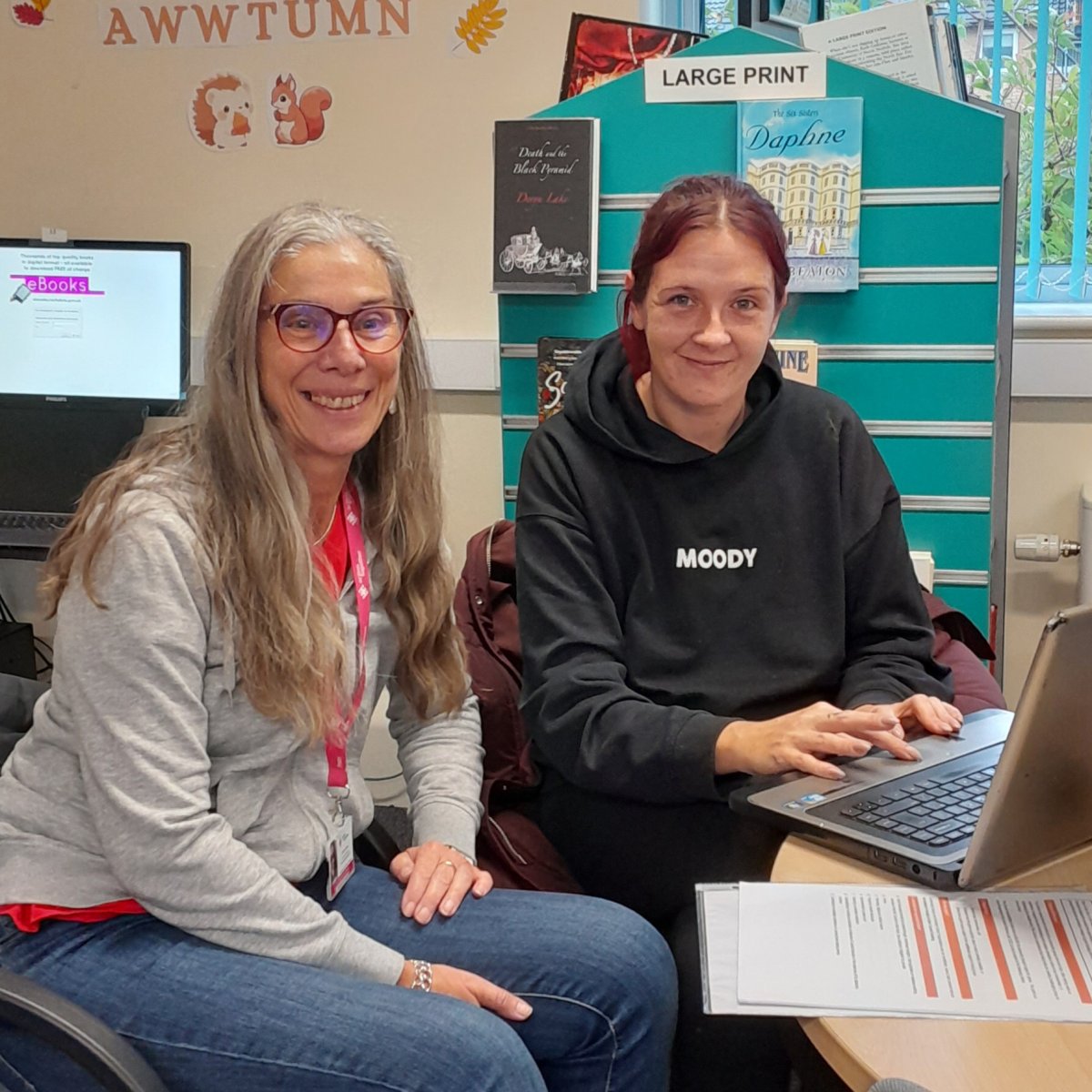 two women at meeting with laptop