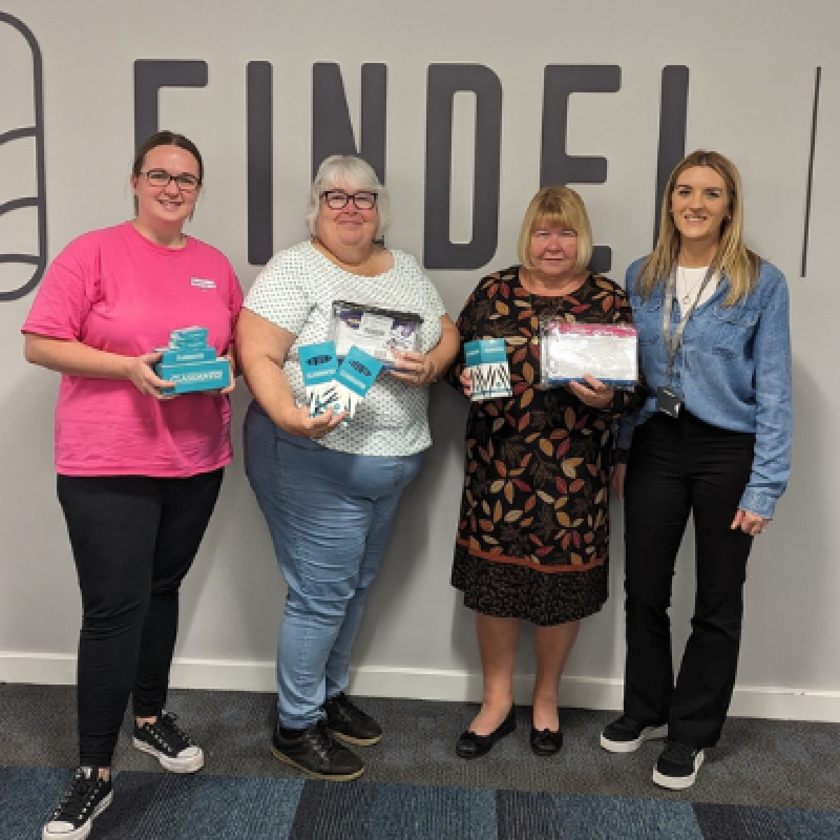 four women smiling holding leaflets