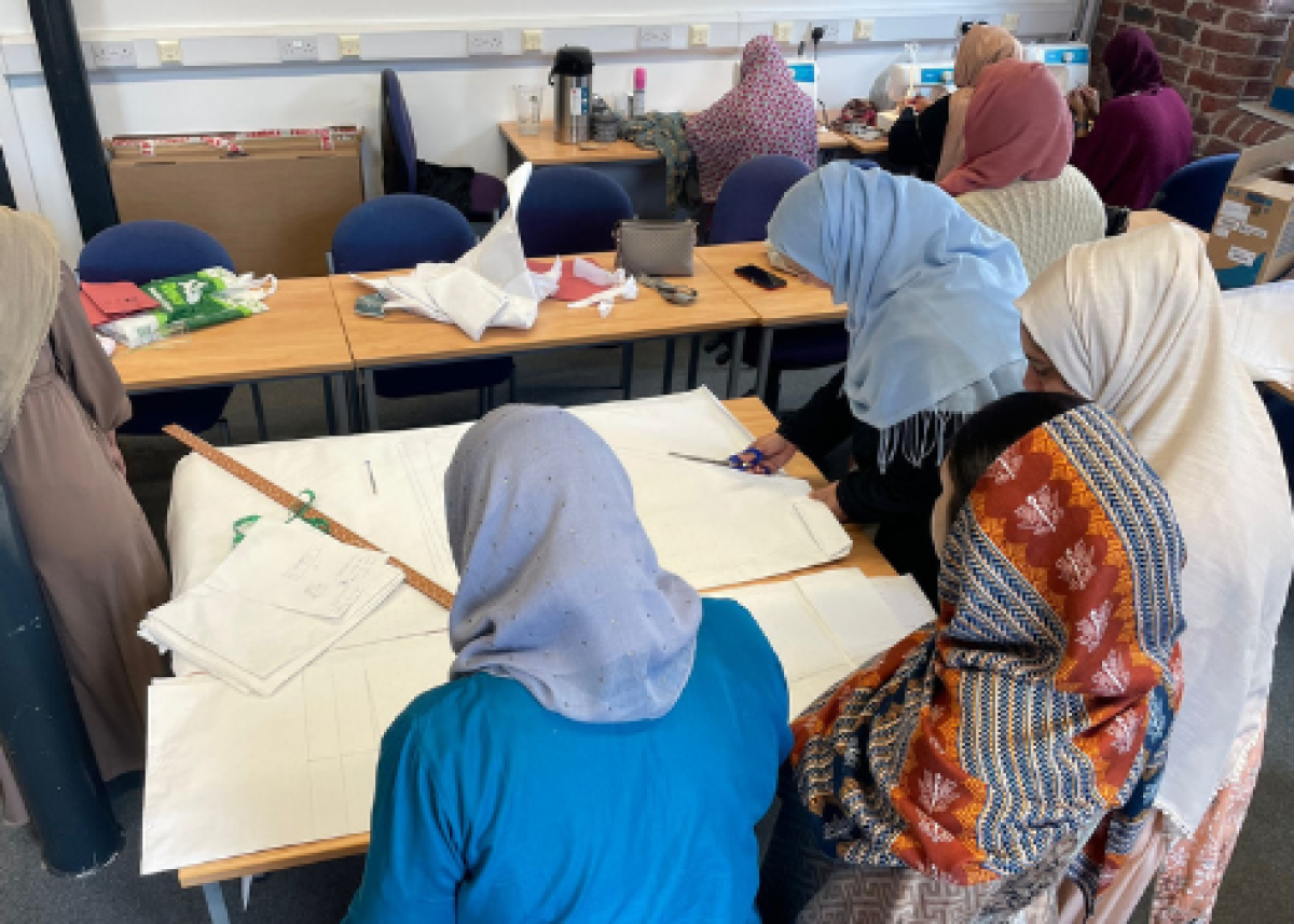 group of women in sewing class working on patterns