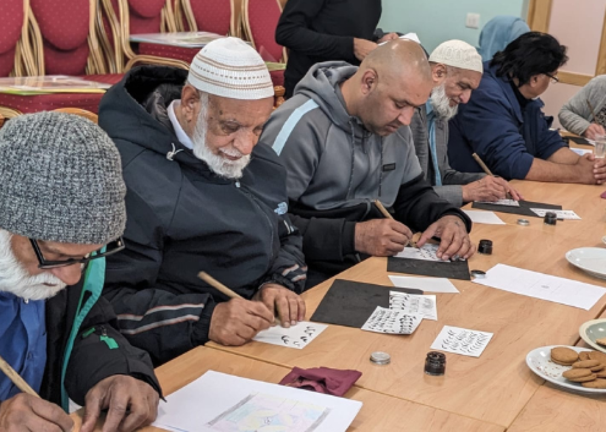 group of men doing calligraphic writing