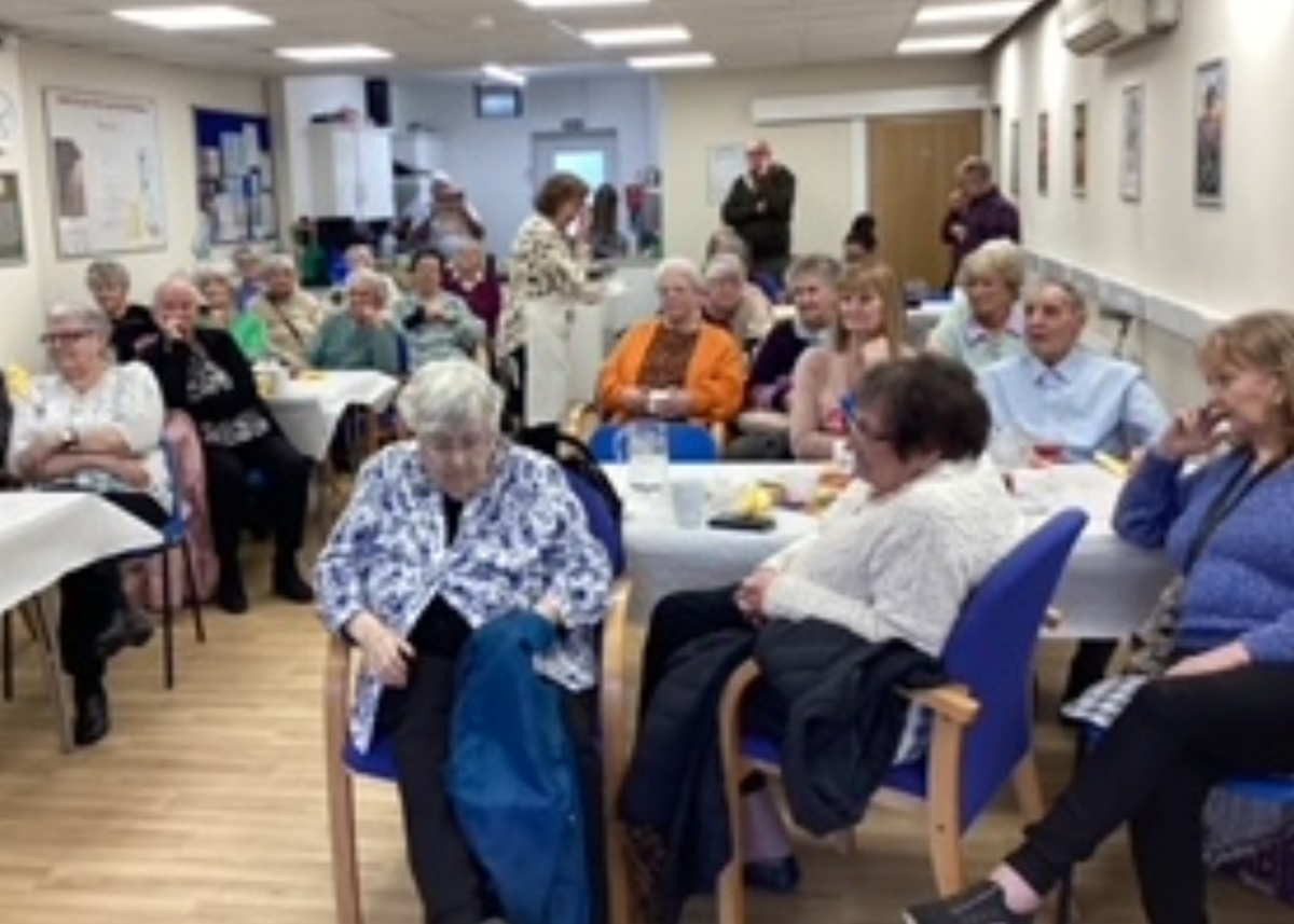 community group of older people sat around tables