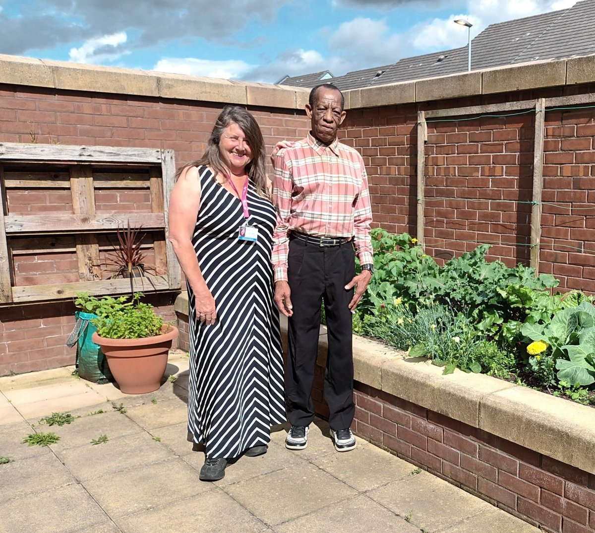 Social Prescriber standing with a client in gardens