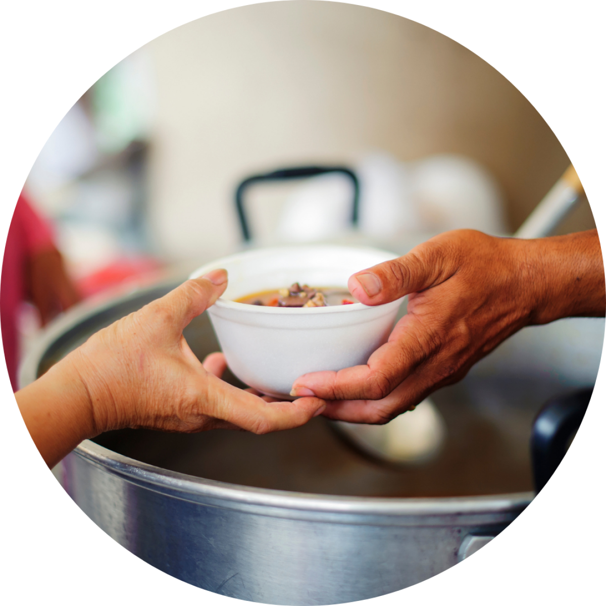 Person passing a bowl of soup