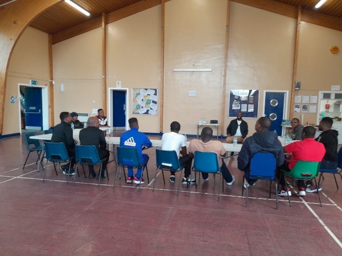 Group of men at community meeting