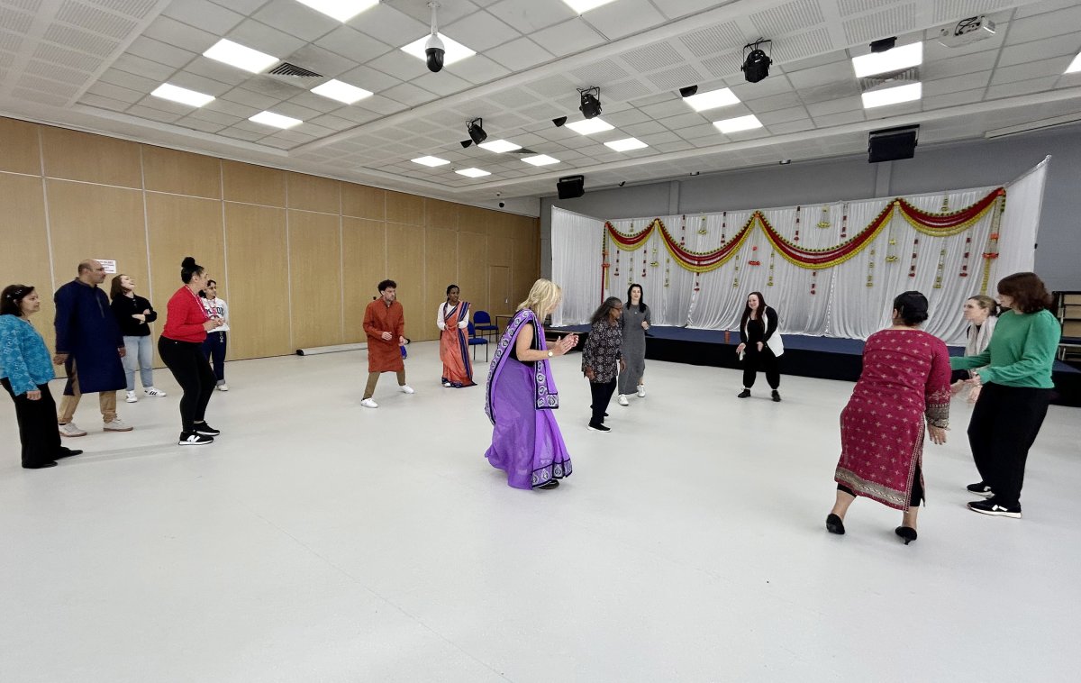 group of people in circle indian dancing