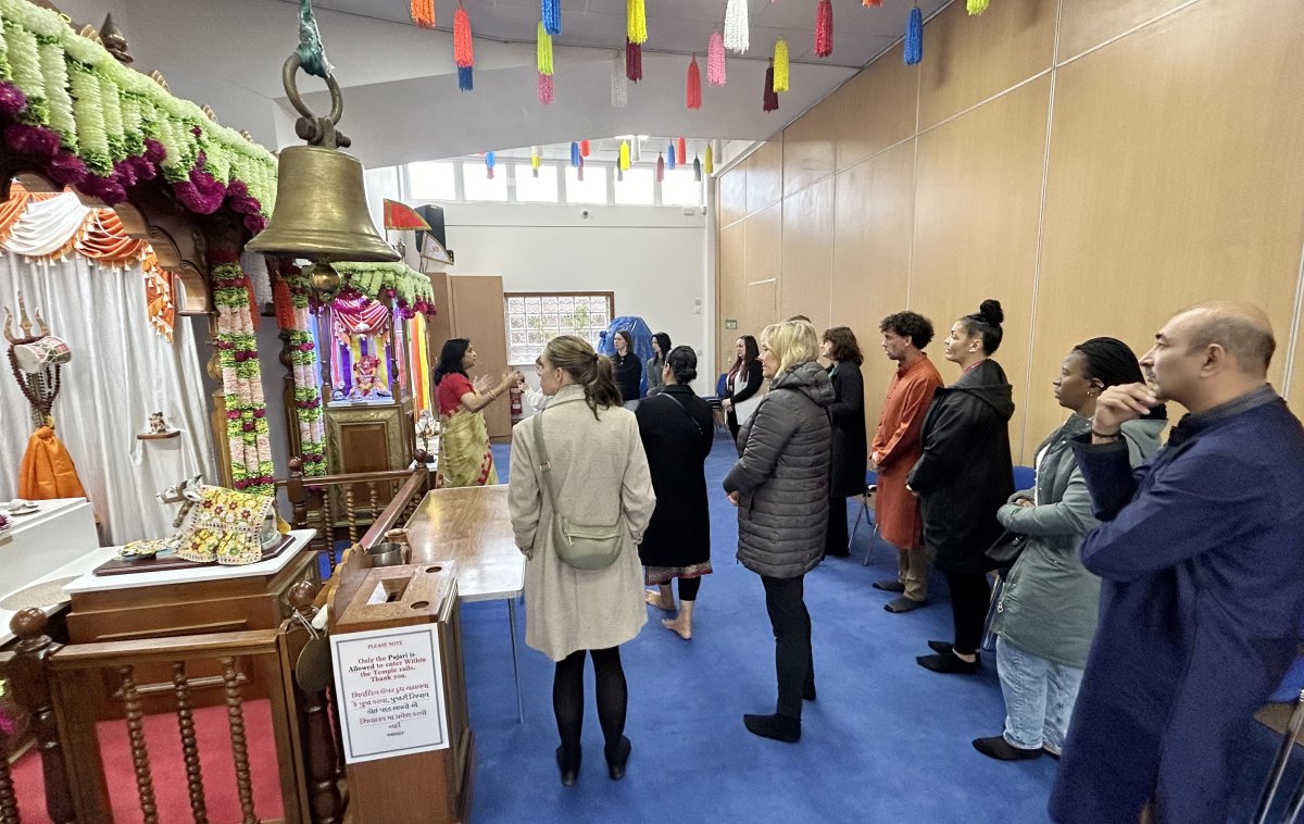 group of people viewing interior of hindu temple