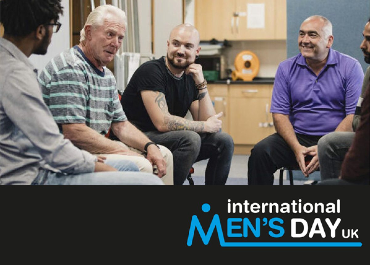 group of men sat chatting with international men's day logo overlaid