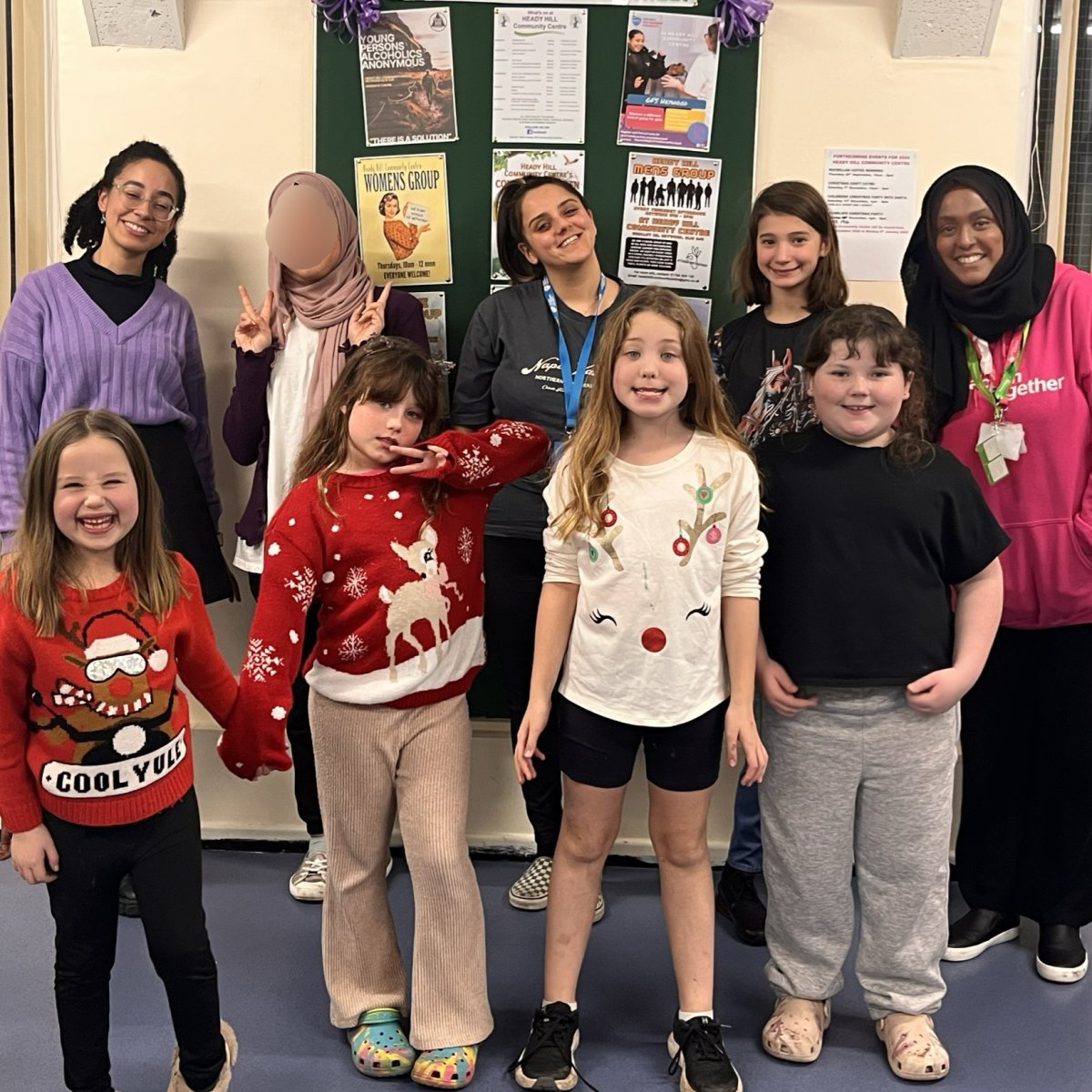 group of smiling women and children at community group